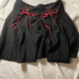 Black stretchy pleated skirt, size large, red ties